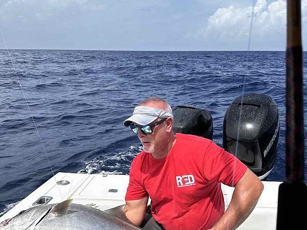 Man on boat holding a catch